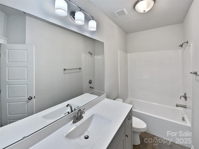 full bathroom featuring vanity, washtub / shower combination, and toilet