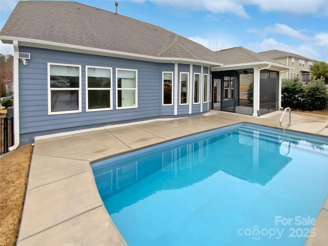 view of pool with a patio, a sunroom, and ceiling fan