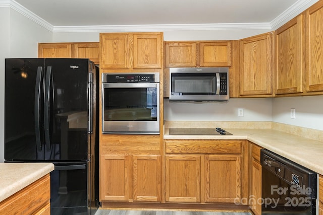 kitchen featuring crown molding and black appliances