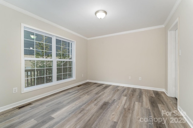 unfurnished room with crown molding and light hardwood / wood-style flooring