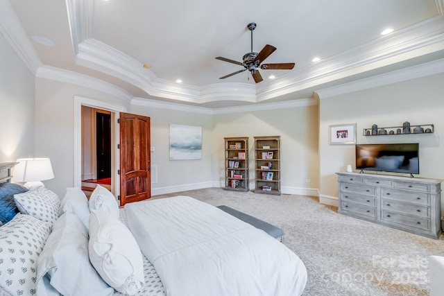 bedroom featuring light carpet, a tray ceiling, crown molding, and ceiling fan