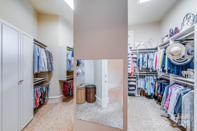 walk in closet featuring light carpet