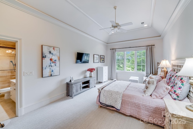 carpeted bedroom featuring ensuite bathroom, lofted ceiling, crown molding, and ceiling fan