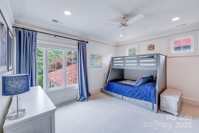 bedroom featuring ceiling fan, ornamental molding, and light colored carpet