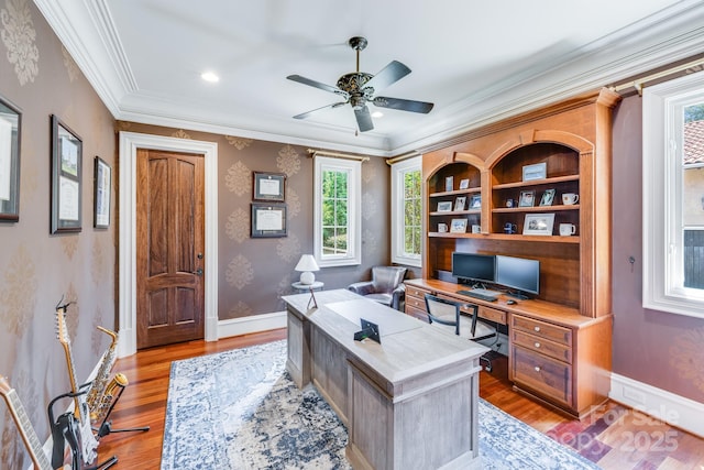 home office featuring crown molding, ceiling fan, light hardwood / wood-style floors, and built in shelves