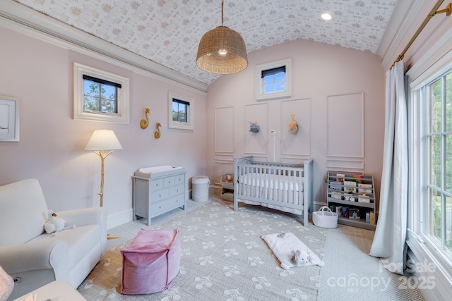 bedroom with lofted ceiling and a crib