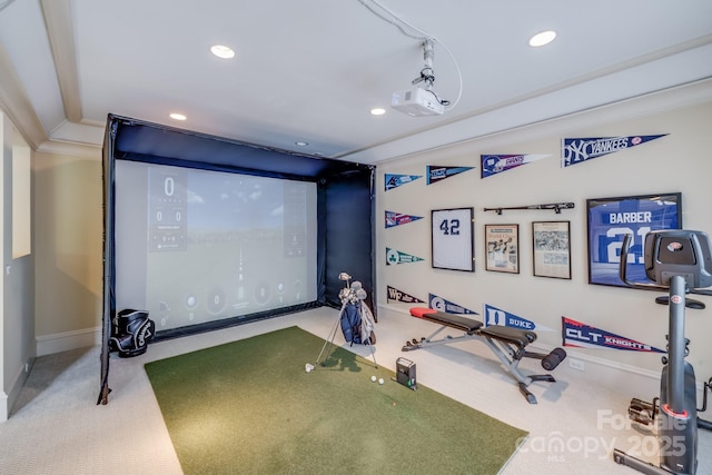 home theater room featuring crown molding, golf simulator, and carpet flooring