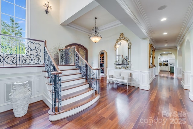 foyer featuring dark hardwood / wood-style flooring and ornamental molding