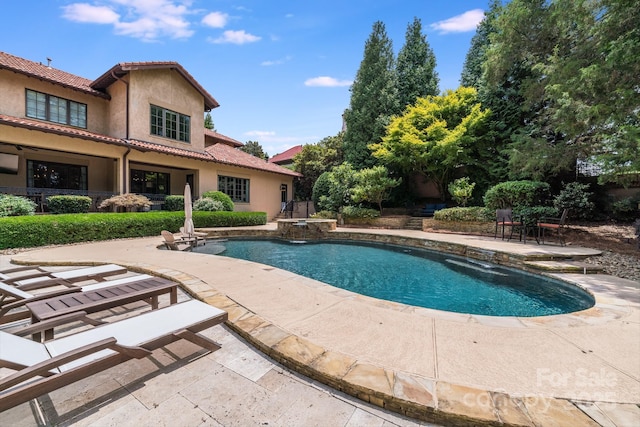 view of swimming pool with a patio area