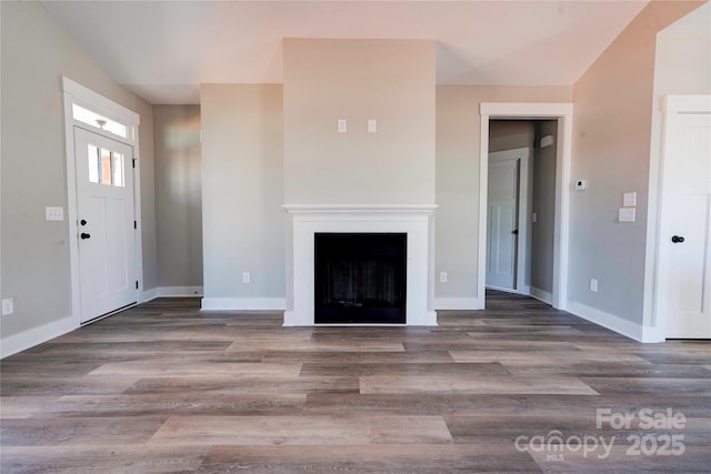 604 E Ridge St, Kings Mountain, NC 28086 - unfurnished living room featuring baseboards, a fireplace, and wood finished floors