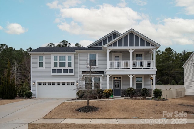 view of front of home with a garage, a balcony, and covered porch