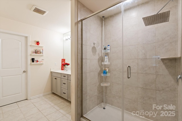 bathroom featuring vanity, an enclosed shower, and tile patterned floors