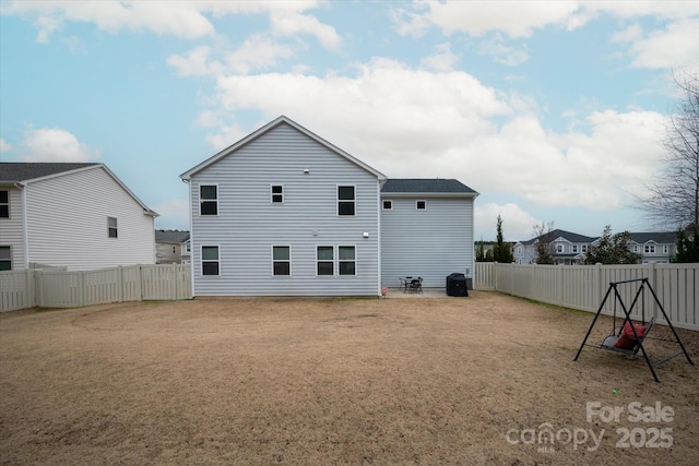 rear view of house with a lawn