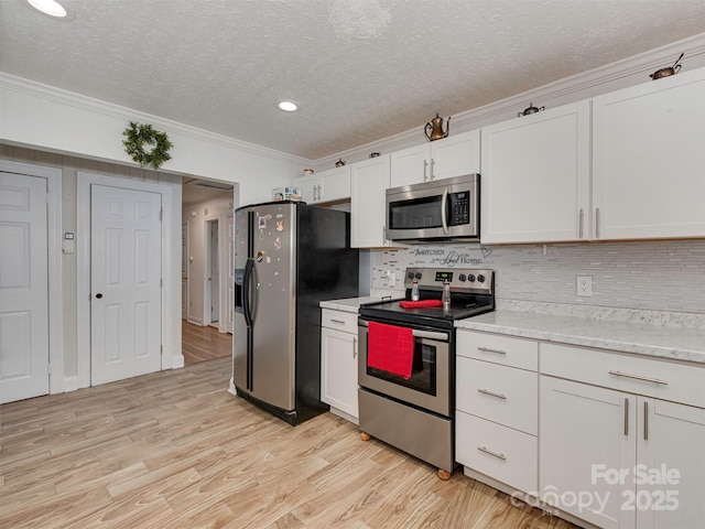 kitchen featuring white cabinetry, crown molding, a textured ceiling, and appliances with stainless steel finishes