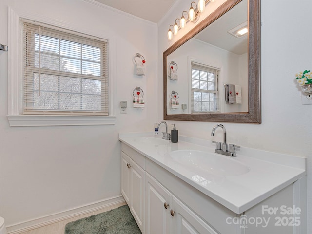 bathroom featuring vanity, a wealth of natural light, and crown molding