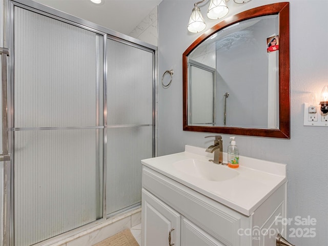 bathroom featuring vanity and a shower with door