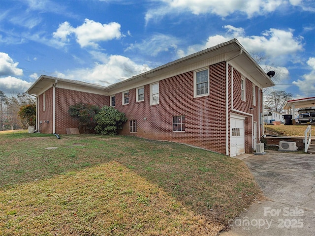 view of home's exterior with cooling unit, a garage, and a lawn