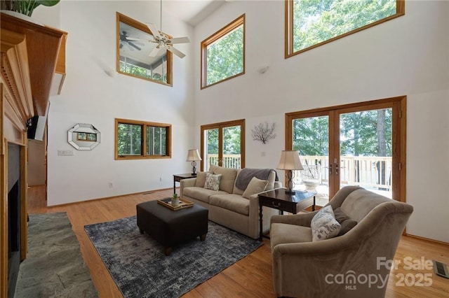 living room featuring french doors, light wood-type flooring, and a wealth of natural light