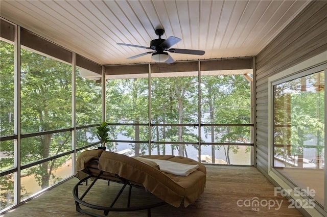 sunroom with ceiling fan and wood ceiling