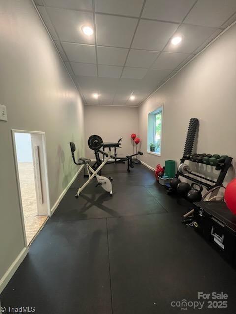 workout room featuring a drop ceiling