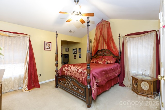 bedroom with ceiling fan, vaulted ceiling, and light carpet