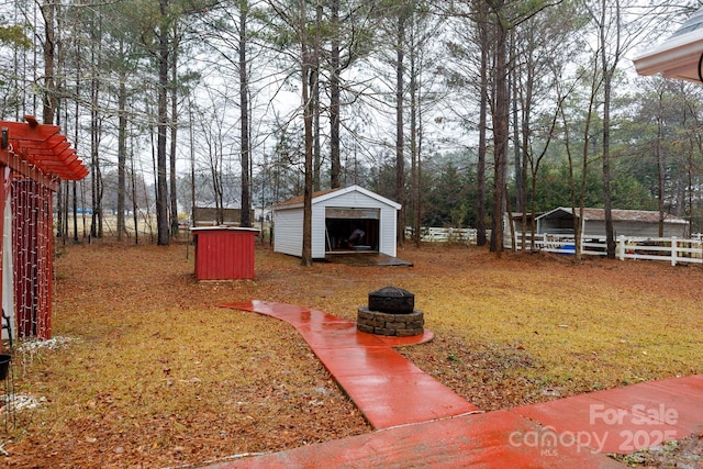 view of yard with a fire pit and a storage unit