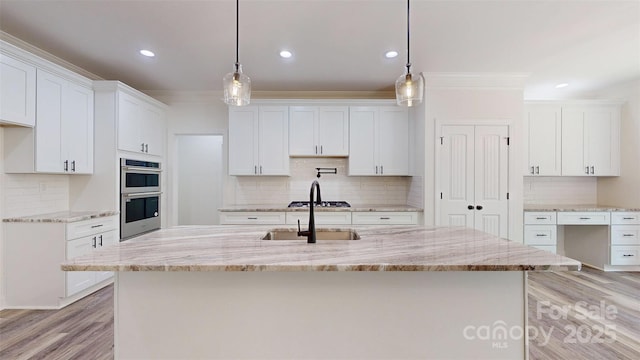 4607 Ferguson Cir, Waxhaw, NC 28173 - kitchen with light wood-type flooring, appliances with stainless steel finishes, a sink, and backsplash