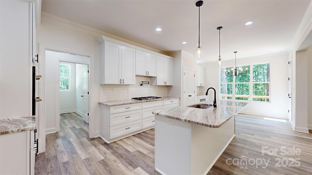 4607 Ferguson Cir, Waxhaw, NC 28173 - kitchen with baseboards, white cabinets, crown molding, and a sink