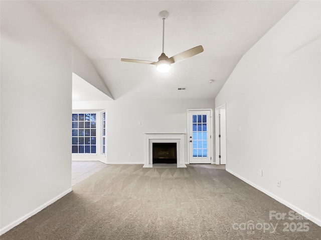 unfurnished living room featuring ceiling fan, carpet floors, and vaulted ceiling