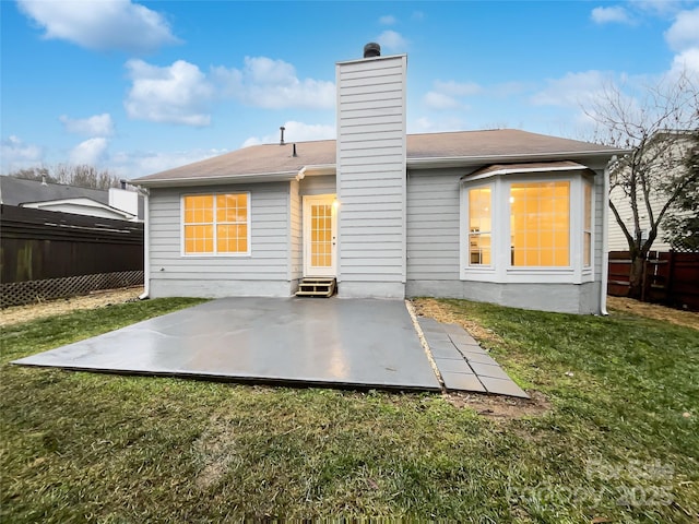 back of house featuring a yard and a patio area