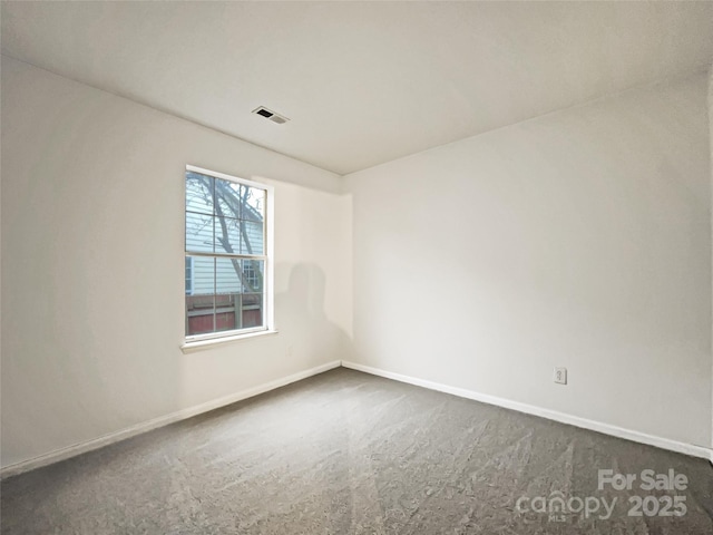 empty room with dark colored carpet