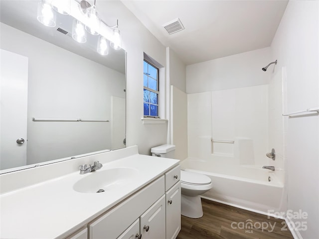 full bathroom with wood-type flooring, toilet, shower / bath combination, and vanity