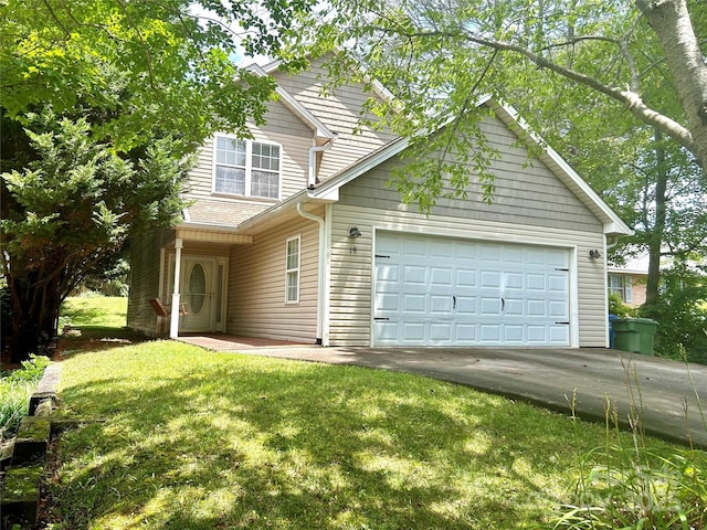 view of front of house featuring a garage and a front lawn