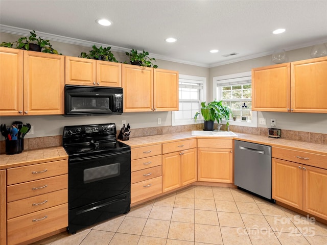 kitchen with sink, tile counters, ornamental molding, black appliances, and light brown cabinetry