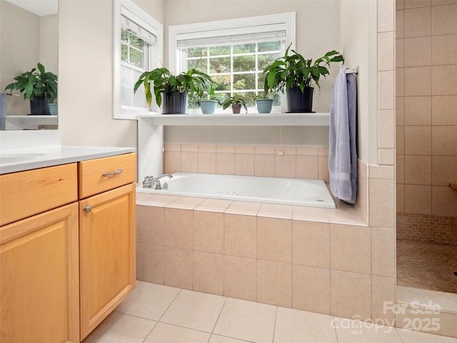 bathroom with tile patterned floors, separate shower and tub, and vanity