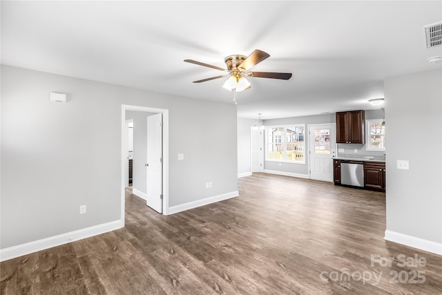 unfurnished living room featuring dark wood-type flooring and ceiling fan