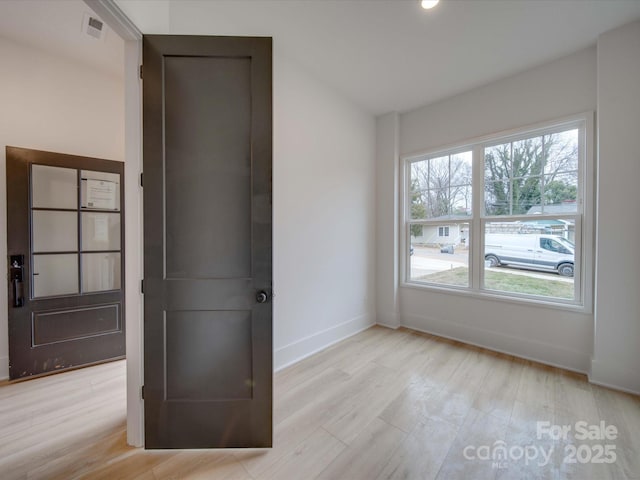 unfurnished room featuring light hardwood / wood-style floors