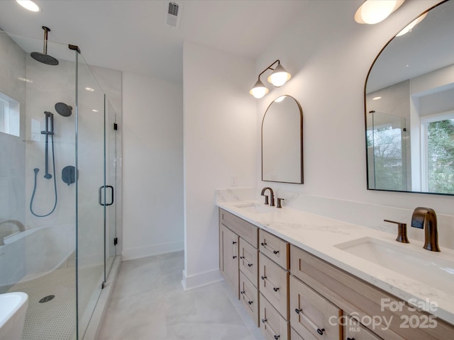 bathroom featuring an enclosed shower and vanity