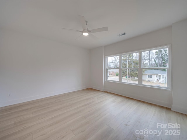 unfurnished room with ceiling fan and light wood-type flooring