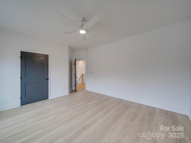 spare room featuring ceiling fan and light hardwood / wood-style flooring