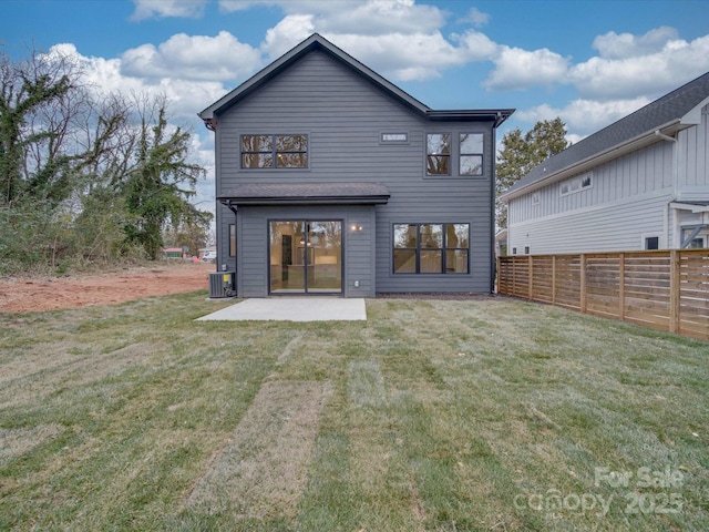 back of house with a patio, a yard, and central air condition unit