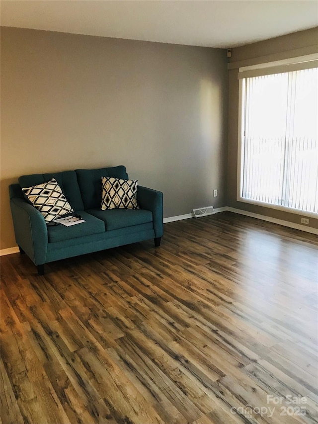 unfurnished living room featuring dark hardwood / wood-style flooring