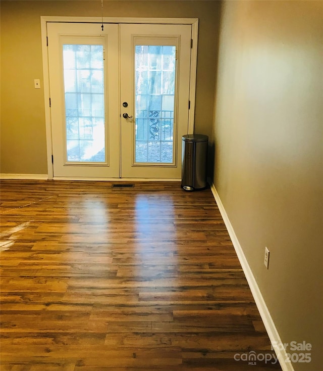 doorway with dark wood-type flooring and french doors