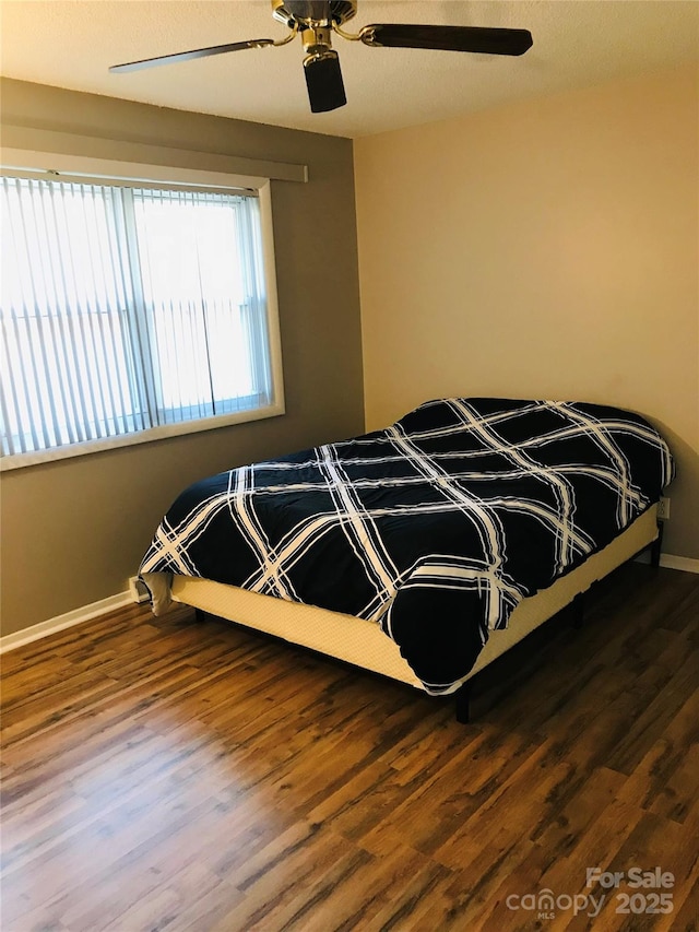 bedroom featuring hardwood / wood-style floors and ceiling fan