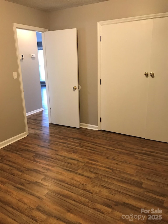 spare room featuring dark hardwood / wood-style flooring