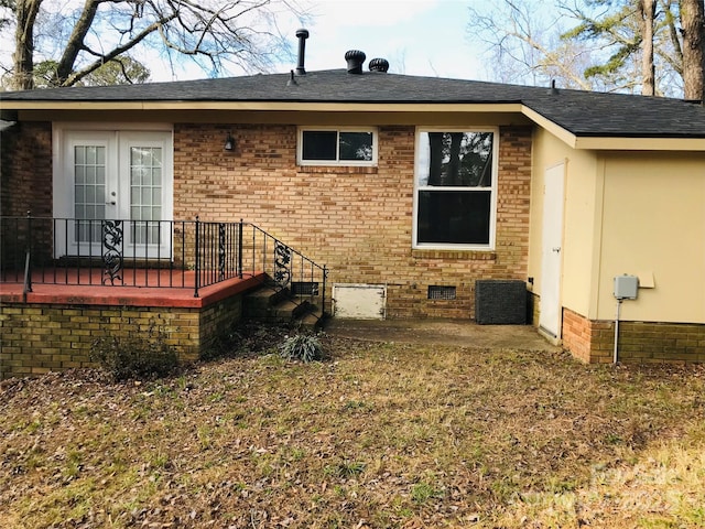 rear view of property featuring french doors and a patio area