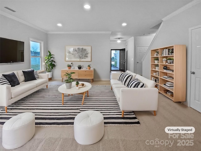 living room featuring ornamental molding, a wealth of natural light, and light colored carpet