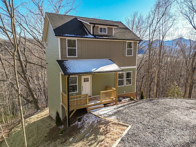 view of front of house featuring a shingled roof and a porch