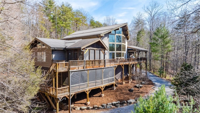 back of house featuring a sunroom and a deck