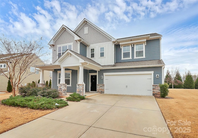 craftsman inspired home featuring a garage and a porch